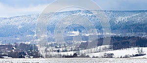 Jagodna Mountain, winter landscape in the Sudetes, view from the field at the foot of the mountain