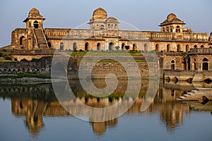 Jahaz Mahal , Ship Palace and blue water lake in sunrise. Mandu, Madhya Pradesh, India. Old Indian architecture on background