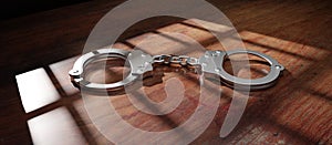 Jail bar shadow and handcuff on a wooden table. Prison, conviction and incarceration. 3d render