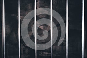 Jail bars, empty dark prison cell