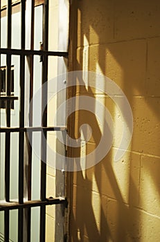 A jail cell door with it`s shadow cast