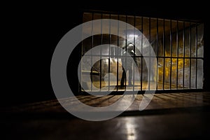 Jail or prison cell. Man in prison man behind bars concept. Old dirty grunge prison miniature. Dark prison interior creative