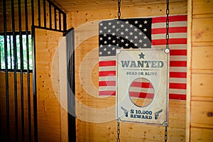 Jail and Wanted Sign in Texas with american flag on the background