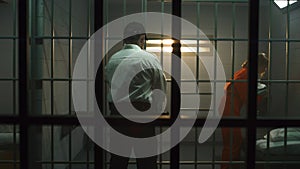Jailer leads female prisoner to prison cell, locks inside