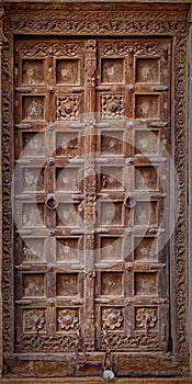 Jaisalmer, India. Old crooked wooden door. Usual entrance to the