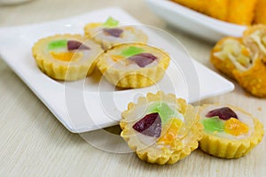Jajanan pasar pie buah or fruit pie and risoles on white plate photo