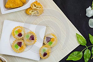 Jajanan pasar pie buah or fruit pie and risoles on white plate photo