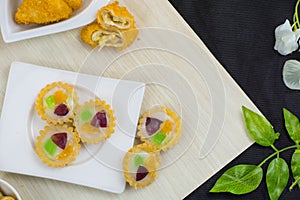 Jajanan pasar pie buah or fruit pie and risoles on white plate photo