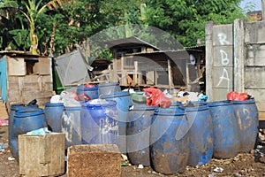 Jakarta, Indonesia - 06082020: Temporary residents` garbage shelter. Blue barrel to store trash. Trash clinic and household trash.