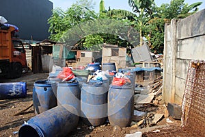 Jakarta, Indonesia - 06082020: Temporary residents` garbage shelter. Blue barrel to store trash. Trash clinic and household trash.