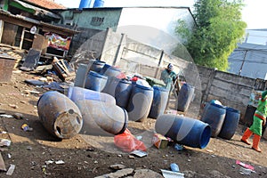 Jakarta, Indonesia - 06082020: Temporary residents` garbage shelter. Blue barrel to store trash. Trash clinic and household trash.