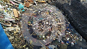 Jakarta, Indonesia - April 2022: environmental pollution, piles of plastic waste scattered in the sea Jakarta, Indonesia.