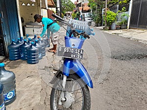 Jakarta, March 17, 2022- a refill water seller who will deliver water on his motorbike