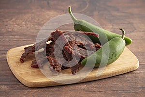 Jalapeno Flavored Gourmet Beef Jerky on a Wooden Cutting Board