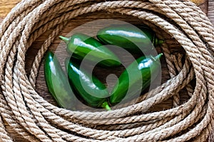 Jalapeno pepper green hot in the center of the rope rope ring close-up top view