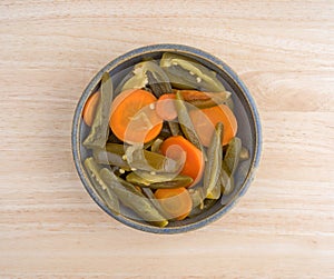 Jalapeno peppers and carrots in a bowl on wood table