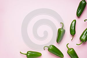 Jalapeno peppers, on a pink background, place for text. Top view