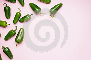 Jalapeno peppers, on a pink background, space for text. Flat lay