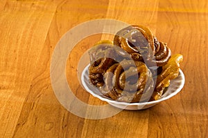 Jalebi Indian sweet dish on a wooden background