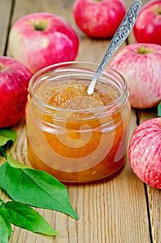 Jam apple with apples and spoon on the board