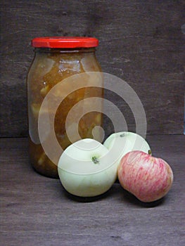 Jam of apple on brouwn wooden background photo