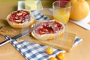 jam bun on a wooden board with table knife