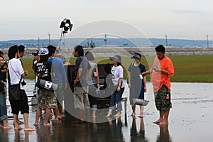 Jam Hsiao filmming with a piano in Gaomei Wetlands