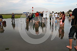 Jam Hsiao filmming with a piano in Gaomei Wetlands