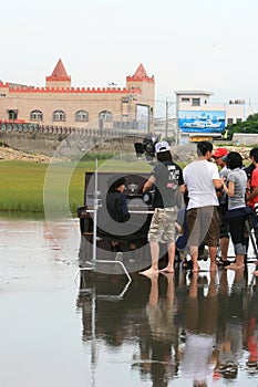 Jam Hsiao filmming with a piano in Gaomei Wetlands