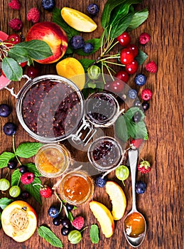 Jam made from different berries in glass jars