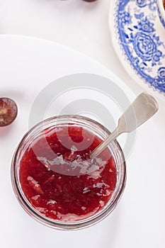 Jam with red grape in a glass jar