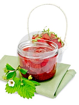 Jam strawberry with basket of berry on napkin