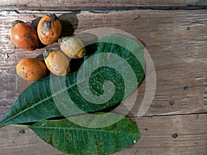 Jambe fruit and leaves on wood background photo