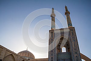 Jameh mosque, with its distinctive tiles minarets, seen at sunset. Jameh mosque is one of the symbols of the city of Yazd