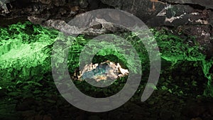 Jameos del Agua in Lanzarote, cave of volcanic origin illuminated with green light and a lake inside