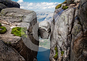 Jammed rock between two cliff walls photo