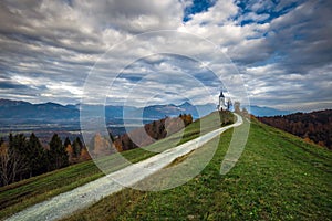 Jamnik, Slovenia - The beautiful church of St. Primoz in Slovenia near Jamnik with beautiful clouds