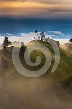 Jamnik, Slovenia - Magical foggy summer morning at Jamnik St.Primoz hilltop church at sunrise