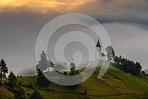 Jamnik, Slovenia - Magical foggy summer sunrise at Jamnik St.Primoz church