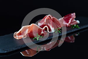 Jamon on a black background photo