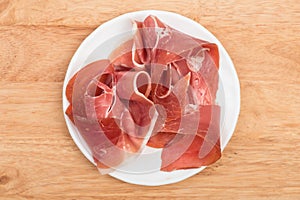 Jamon ham on dish over wooden background