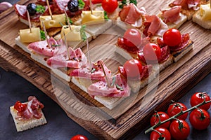 Jamon, ham, sausage and cheese on crusty garlicy bread or pinxtos, spanish cuisine