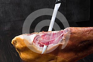 Jamon. Jamon serrano. Traditional Spanish ham on black close up.