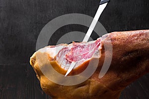 Jamon. Jamon serrano. Traditional Spanish ham on black close up.