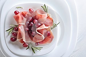 Jamon serrano with rosemary and grape .