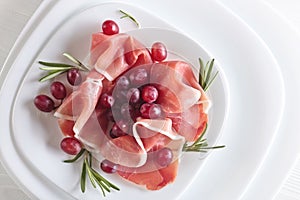 Jamon serrano with rosemary and grape .