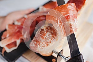 Jamon serrano. Traditional Spanish ham, Slicing of dry-cured ham in Spain