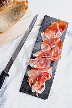 Jamon serrano. Traditional Spanish ham, Slicing of dry-cured ham in Spain