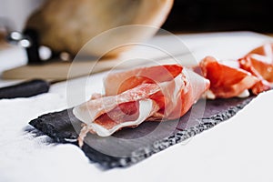 Jamon serrano. Traditional Spanish ham, Slicing of dry-cured ham in Spain