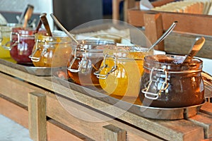 Jams in glass jars with spoon